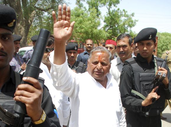 Samajwadi Party Chief Mulayam Singh Yadav waves to his supporters after filing his nomination at Mainpuri in Uttar Pradesh