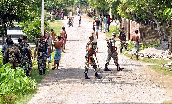Army men patrol a violence-hit area in a district in Assam