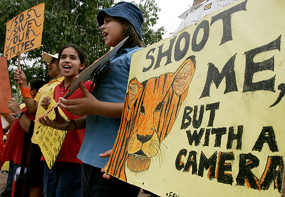Children shout slogans as they take part in a campaign to save tigers from poaching in New Delhi