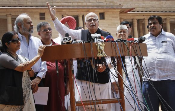 Senior BJP leader LK Advani speaks to the media while party president Gadkari, Leader of Opposition Sushma Swaraj and other leaders look on, in New Delhi