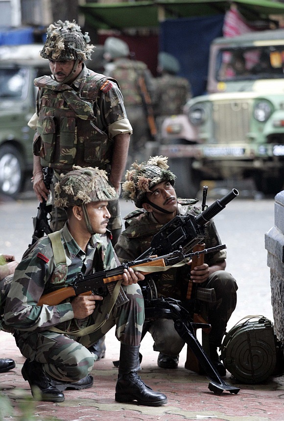 Soldiers take positions outside Taj Mahal Hotel during a gun battle in Mumbai on November 29, 2008