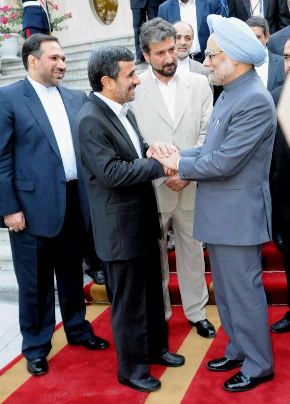 Iran President Ahmadinejad interacts with Dr Singh