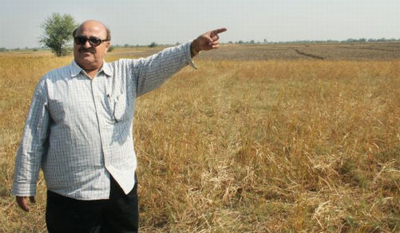 Ashrafbhai Pathan points towards the cast stretches of land he recently sold to GIDC