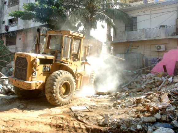 A bulldozer razes the temple in Karachi