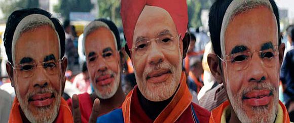 Modi's supporters wear masks depicting their leader