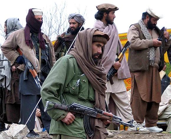 Armed tribesmen stand guard during a traditional tribal assembly in Sararogoha, about 80 km northeast of Wana, the main town of the South Waziristan tribal region