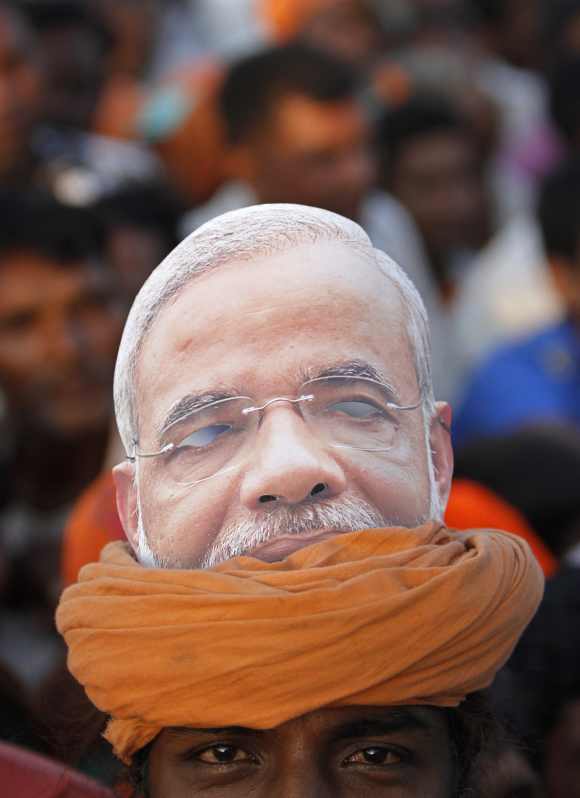 A supporter with a picture of Modi on his turban attends an election campaign rally ahead of the state assembly elections at Pavagadh town, in  Gujarat