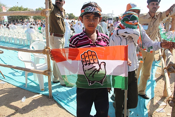 A boy holds the Congress flag at the rally