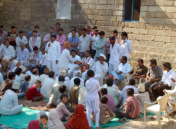 A village elder interacts with Jadeja at the gathering