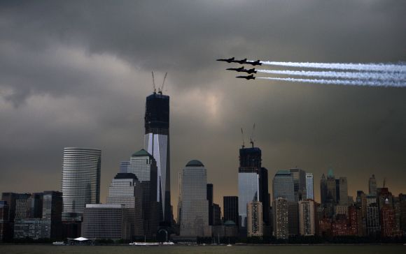Members of the U.S. Navy Blue Angels fly over the World Trade Center as part of Fleet Week celebrations in New York