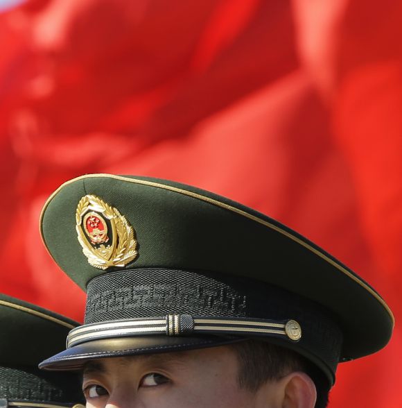 A Chinese paramilitary police official keeps watch on Beijing's Tiananmen Square