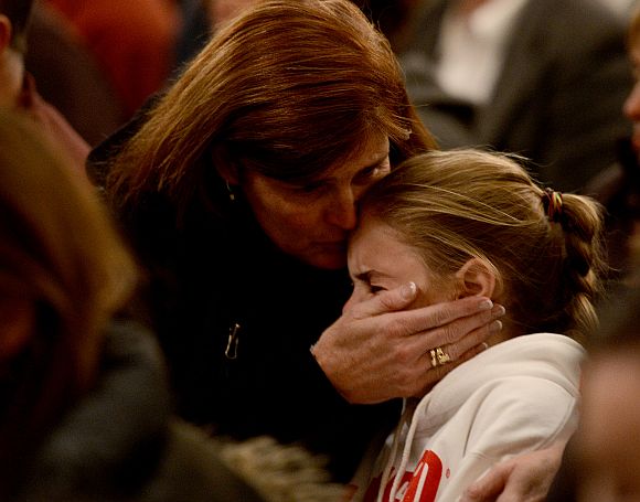 Mourners gather inside the St. Rose of Lima Roman Catholic Church at a vigil service for victims of the Sandy Hook School shooting