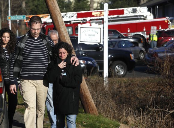 Families leave the Sandy Hook Volunteer Fire Department near the Sandy Hook Elementary School in Newtown, Connecticut,