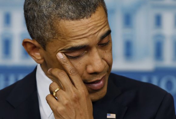 U.S. President Barack Obama wipes a tear as he speaks about the shooting at Sandy Hook Elementary School in Newtown, Connecticut