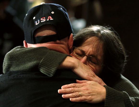 A woman hugs a man during a vigil for families of victims of the Sandy Hook Elementary School shooting in Newtown