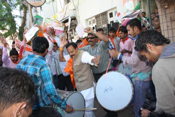 BJP workers dance outside the party headquarters in Khanpur as the news of Modi's victory from the Maninagar constituency comes in
