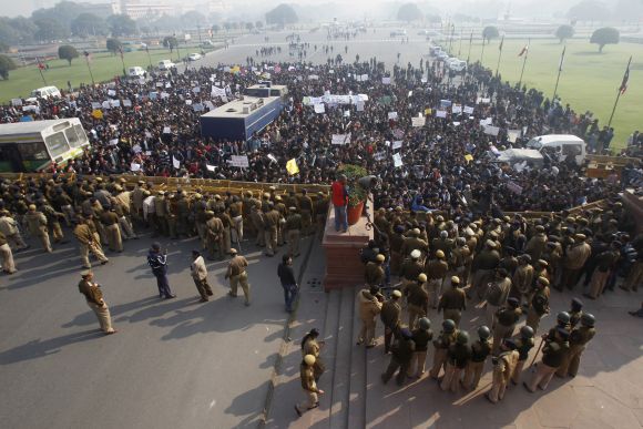 Police try to block demonstrators near the presidential palace during a protest rally in New Delhi.