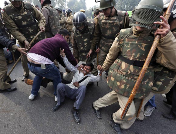 Police detain demonstrators in front of the India Gate during a protest in New Delhi