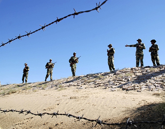 Border Security Force soldiers patrol the border at the India-Pakistan International Border Post, about 180 km from Bikaner