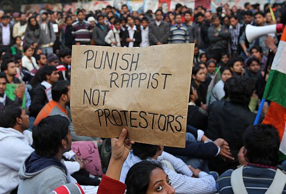 A demonstrator holds a placard during a protest in New Delhi