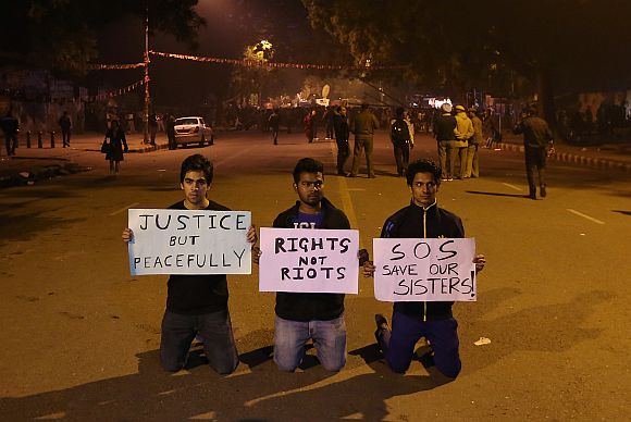 emonstrators hold placards during a protest in New Delhi