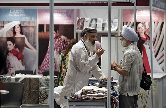A Pakistan exhibitor speaks with a Sikh visitor at the Lifestyle Pakistan Exhibition in New Delhi