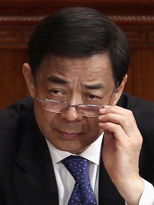 China's then Chongqing Municipality Communist Party Secretary Bo Xilai adjusts his glasses during the opening ceremony of the Chinese People's Political Consultative Conference at the Great Hall of the People