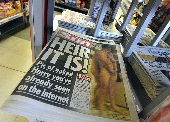 A copy of The Sun newspaper featuring a picture of a naked Prince Harry is seen in a shop in London