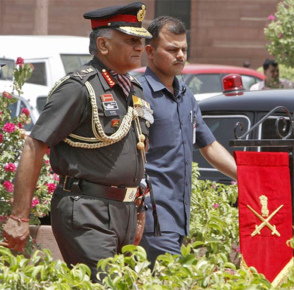 Former Indian Army Chief General Vijay Kumar Singh walks to inspect his guard of honour outside the defence ministry building in New Delhi
