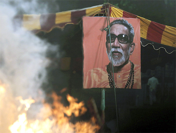 A portrait of right-wing Hindu nationalist politician Bal Thackeray is pictured through the heat haze rising from his cremation pyre during his funeral at Shivaji Park in Mumbai