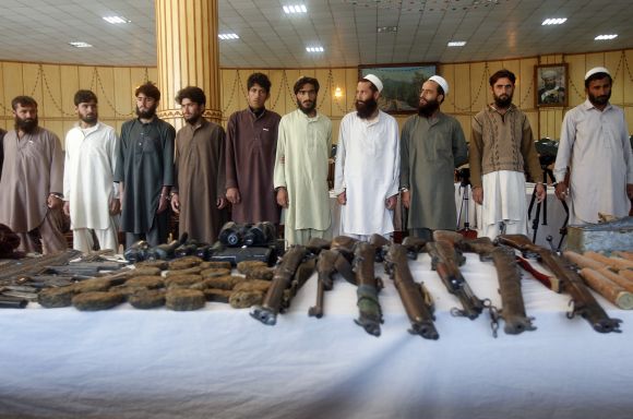 Taliban insurgents and their weapons confiscated by Afghan joint forces during an operation are presented to the media in Jalalabad province