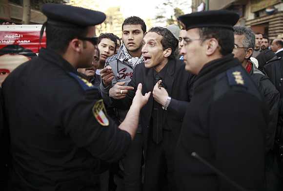 A demonstrator talks with police officials during a protest condemning the deaths that happened on Wednesday at Port Said stadium