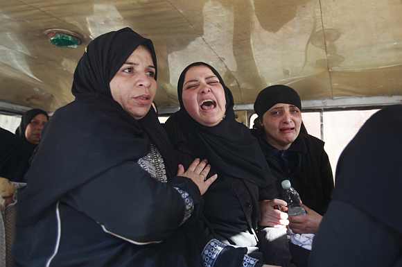 Relatives of victims killed in Port Said stadium cry as they wait to receive the bodies at a morgue in Cairo