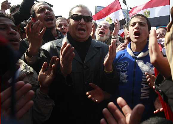 Supporters of al-Ahly soccer club pray for the souls of the victims killed in Port Said stadium during a protest in Cairo