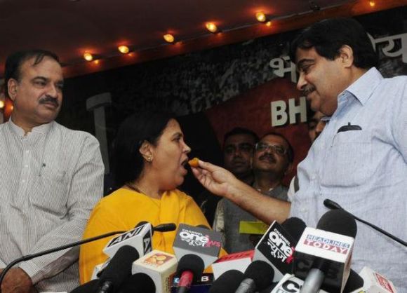 BJP President Nitin Gadkari, right, would not have bragged about bringing in Uma Bharti, centre, as a star campaigner had Bharti not been a Lodh