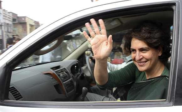 Priyanka Gandhi waves to supporters of the party after her address at an election campaign rally at Amethi