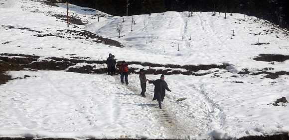 Children play in snow in Srinagar