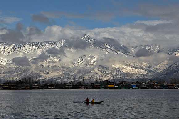 Women row a boat in Dal Lake