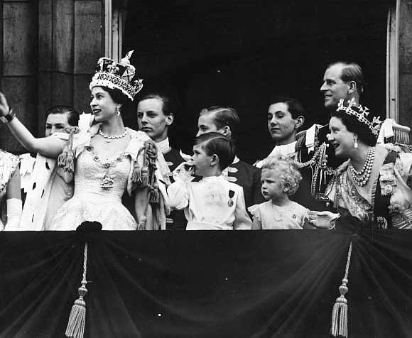 Queen Elizabeth II with (left to right) Charles, Prince of Wales, Anne the Princess Royal, Prince Philip the Duke of Edinburgh, and the Queen Elizabeth the Queen Mother watching an RAF fly-past from the balcony of Buckingham Palace as part of the Queen's Coronation ceremony on June 2, 1953