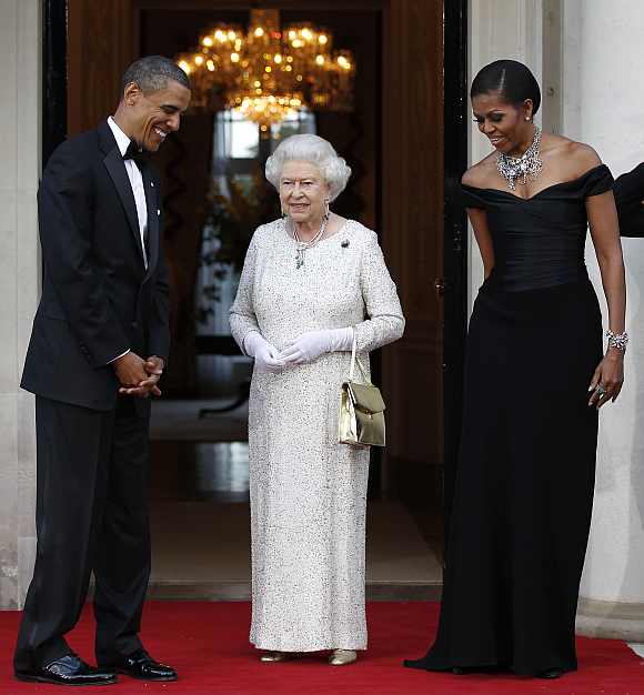 US President Barack Obama and first lady Michelle Obama welcome Britain's Queen Elizabeth to the Winfield House for dinner in London, May 25, 2011