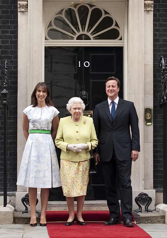 Britain's Queen Elizabeth poses with Prime Minister David Cameron and his wife Samantha before a lunch to celebrate Prince Philip's 90th birthday at number 10 Downing Street in London