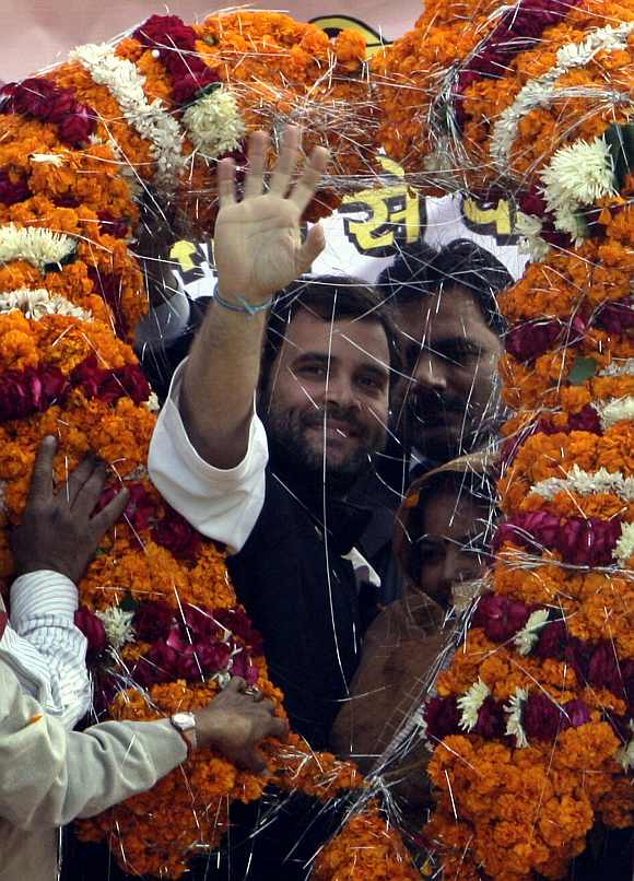 Rahul Gandhi waves to his supporters after receiving a garland from his party workers during an election campaign rally at Jari village, in the northern Indian state of Uttar Pradesh