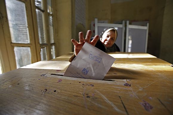 A woman casts her vote during the second round of parliamentary run-off elections at Shubra in El-Kalubia, on the outskirts of Cairo