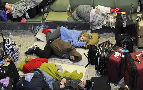 Passengers sleep on makeshift beds in Terminal 3 at Heathrow Airport in west London