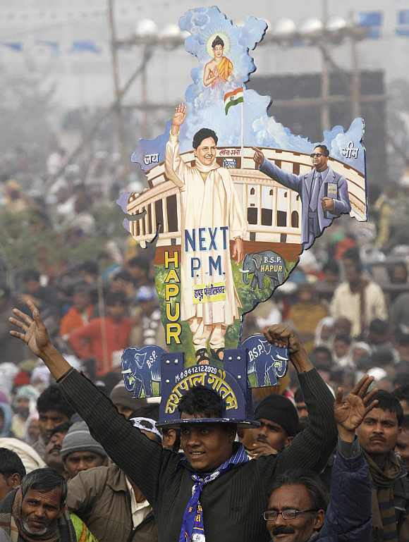 A supporter holds a cutout of the map of India with images of UP Chief Minister Mayawati and BR Ambedkar in Lucknow