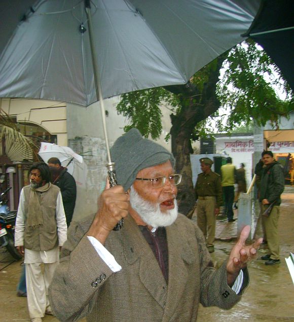 Mohammad Qazi speaks to the media outside a polling station in Barabanki
