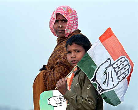 A woman and a child leave after listening to Rahul Gandhi at a campaign rally in Hardoi, UP