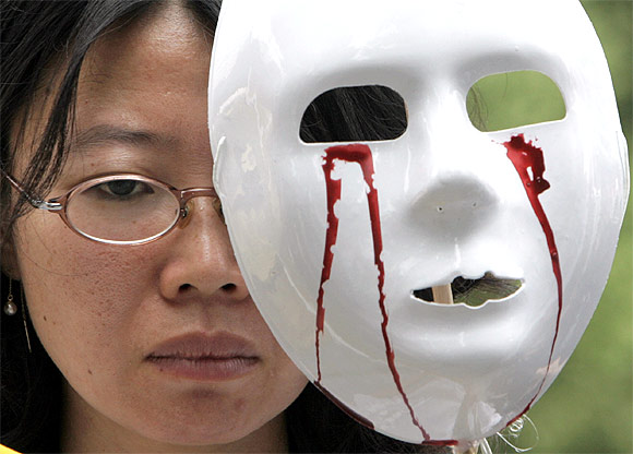 A protester holds a mask during an anti-war rally in Seoul, South Korea