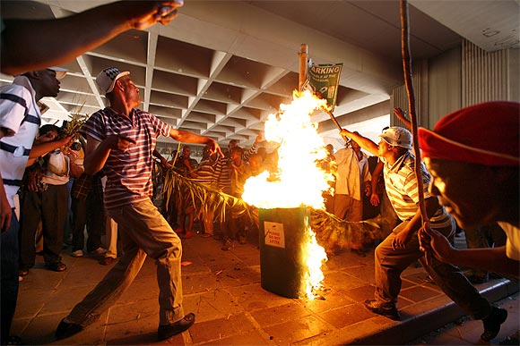 Angry taxi operators set fire to rubbish bins during a march in Cape Town