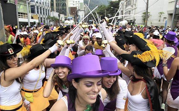 Revellers attend a samba parade during pre-carnival festivities in Rio de Janeiro